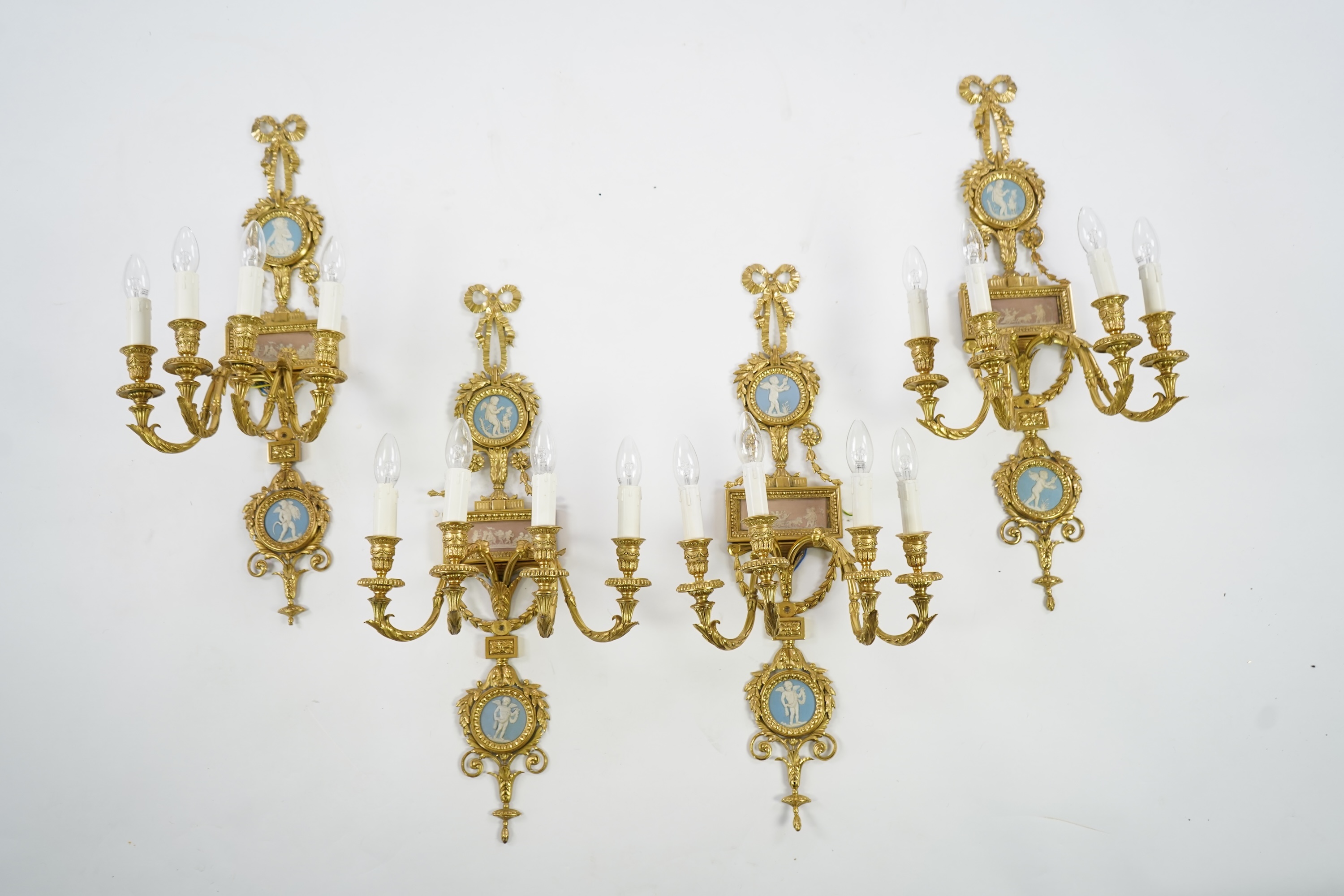 A set of four Adam style ormolu and jasper ware mounted wall appliques, early 20th century